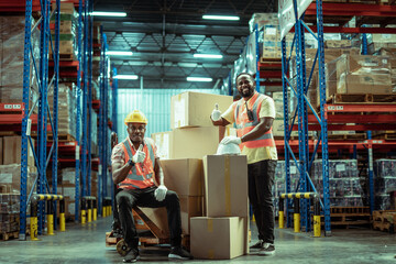 Two African American warehouse workers showing teamwork and partnership. teamwork at warehouse...