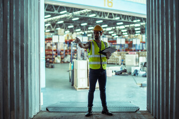 Caucasian male worker wearing Hard Hat with clipboard Checks Stock and Inventory in the Retail Warehouse.