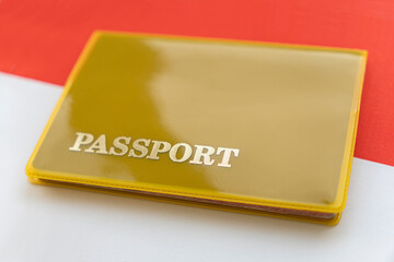 Flag of indonesia with passport. Travel visa and citizenship concept. residence permit in the country. a yellow document with the inscription passport is on flag. Close up, top view