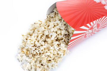 Popcorn in red and white striped cardboard bucket isolated on white background