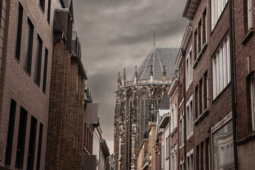 Aachen Cathedral seen from the old town with residential buildings. Aachen Cathedral, or Aachener Dom, is the main landmark of Aachen and a catholic church in Germany.