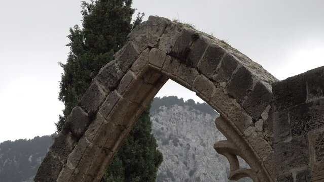 Arches of damaged church and monastery of Bellapais Abbey, religion and culture in Northern Cyprus