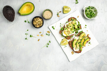 toasts with rye bread, sliced avocado, cheese. Delicious breakfast or snack, Clean eating, dieting, vegan food concept. top view