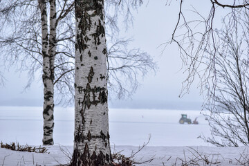 Snowblower grader clears snow covered road. A heavy snowstorm swept the road.