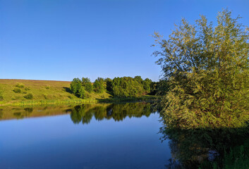 Fototapeta na wymiar view of a calm lake in summer in Ukraine
