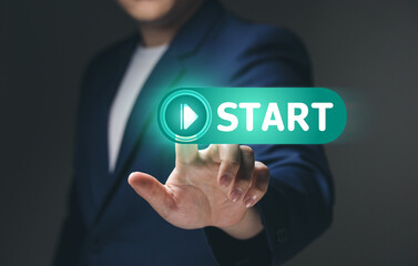Businessman touch on virtual screen start button for business concept of new start, business planning, strategies and challenges or career paths, opportunities, and changes.