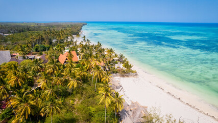 The turquoise ocean water and the luxurious resort on Kiwengwa beach in Zanzibar, Tanzania, are captured in this gorgeous toned aerial view. The scenery is simply stunning, and it's a perfect destinat