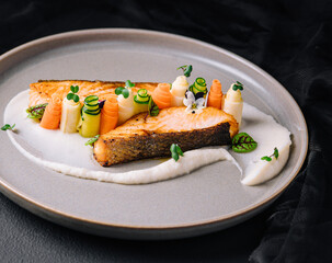 Salmon fish steak grilled and fresh beautifully decorated vegetables
