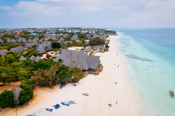 The picturesque Nungwi beach in Zanzibar, Tanzania is showcased in a toned aerial view image, highlighting the luxury resort and turquoise ocean waters.