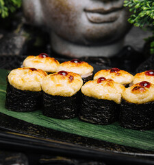 Served warm sushi rolled in nori sheets