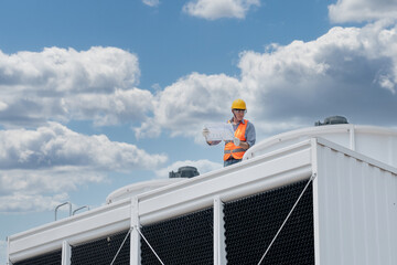 Industry engineer under checking the industry cooling tower air conditioner is water cooling tower...