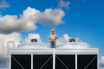 Industry engineer under checking the industry cooling tower air conditioner is water cooling tower...