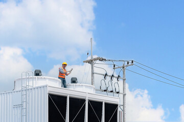 Industry engineer under checking the industry cooling tower air conditioner is water cooling tower...
