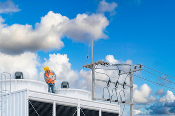 Industry engineer under checking the industry cooling tower air conditioner is water cooling tower...