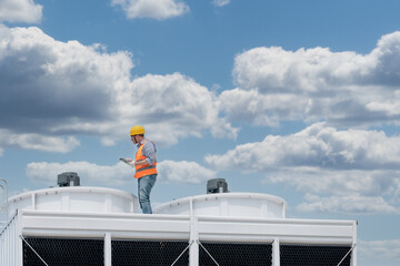 Industry engineer under checking the industry cooling tower air conditioner is water cooling tower...