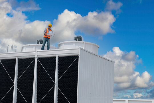 Industry Engineer Under Checking The Industry Cooling Tower Air Conditioner Is Water Cooling Tower Air Chiller HVAC Of Large Industrial Building To Control Air System.