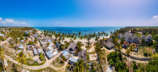 The turquoise ocean water and the luxurious resort on Kiwengwa beach in Zanzibar, Tanzania, are captured in this gorgeous toned aerial view. The scenery is simply stunning, and it's a perfect destinat
