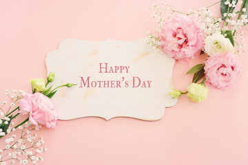Naklejka na ściany i meble mother's day concept with pink flower over pastel background
