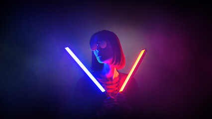 Neon close up portrait of young woman in red sunglasses with glow sticks.