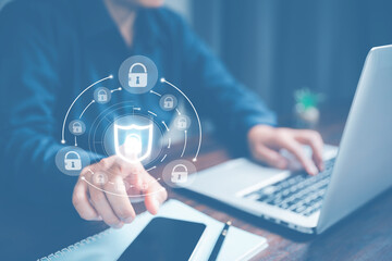 Cybersecurity and privacy concepts to protect data. Lock icon and internet network security technology. Businesswoman protecting personal data on laptop computer with virtual screen interfaces.