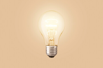 Light bulb glow on a beige background. Technology and science