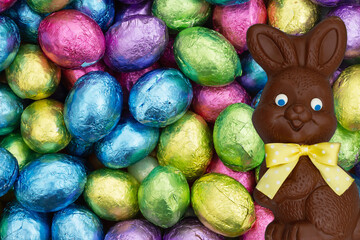 Blank shiny Easter eggs greeting card with chocolate Easter Bunny