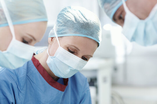 Calm and focused medical professional. Closeup of a female surgeon working with her colleagues in surgery.