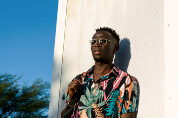 Thoughtful young man of African ethnicity, looking towards the horizon.