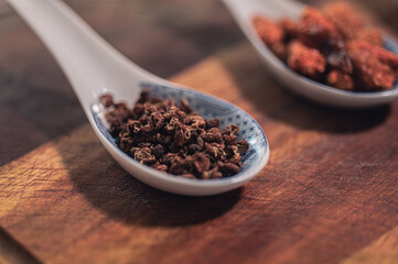 peppercorns on spoons