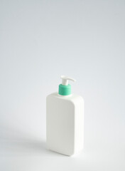 Large white plastic bottle with pump dispenser as a liquid container for gel, lotion, cream, shampoo, bath foam on white background.