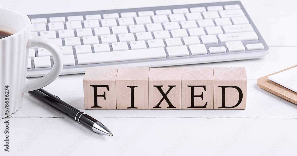 Aufkleber fixed word on the wooden blocks with keyboard and coffee