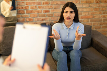 Mental health and psychological assistance concept. Teen indian lady having counseling session with...
