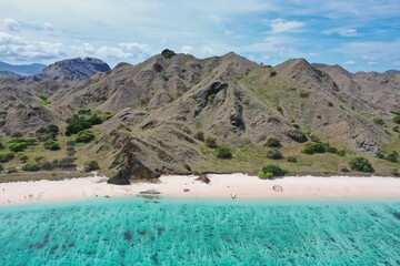 Fototapeta na wymiar Paradise panoramic bird's eye view of Komodo National Park on Flores with turquoise sea, Pink Beach and hills.
