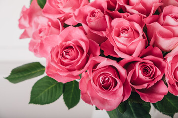 Beautiful bunch of fresh pink roses in full bloom against white background, close up. Bouquet of flowers. Valentine's day or Mother's day card.