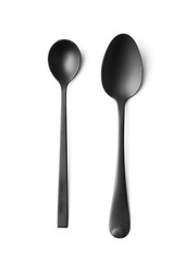 Black spoons on white insulation top view