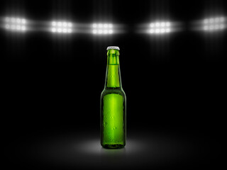 Green bottle of fresh beer with drops of condensation on a black background under stadium lights....
