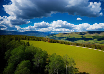 Obraz premium a green field with mountains in the background, prismatic cumulus clouds, boreal forest, widescreen, rocky mountains, without green grass, lush farm lands, test, full width, blue wall