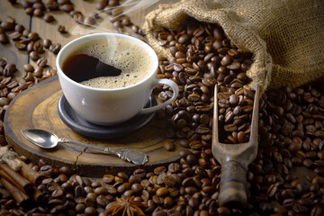 Espresso coffee with coffee beans on old background.