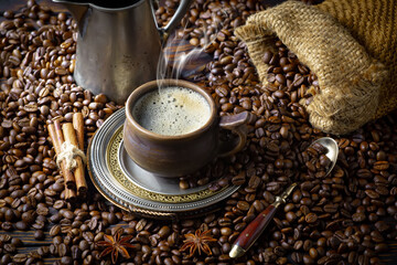 Espresso coffee with coffee beans on old background.