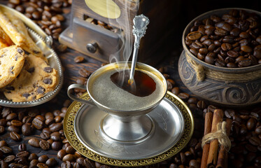 Espresso coffee with coffee beans on old background.