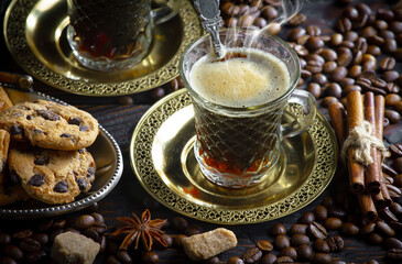 Espresso coffee with coffee beans on old background.