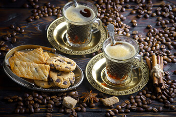 Espresso coffee with coffee beans on old background.