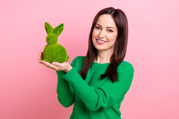 Portrait of cheerful lovely lady toothy smile arms hold showing fluffy easter bunny toy isolated on...