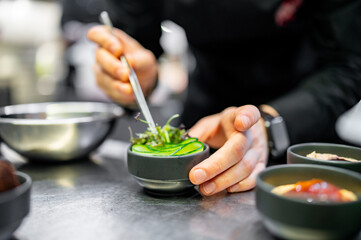 Chef cooking vegetables salad on restaurant kitchen