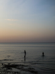 silhouette of peoples at the beach during sunset