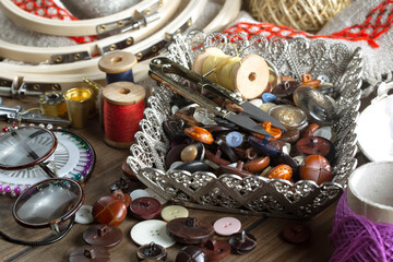 Colored threads and items for sewing, on an old background.