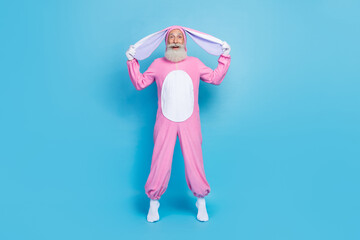 Full length photo of astonished man dressed pink rabbit costume arms hold ears impressed staring...