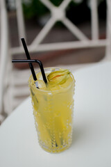 Summer cocktail with fruit. Drink on a white table in the sunlight . Summer, tropical, fresh cocktail concept.