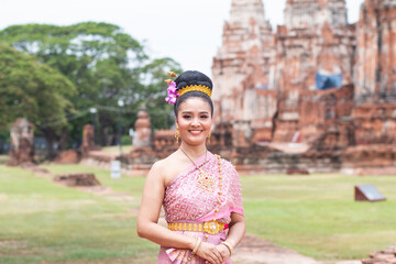 Fototapeta na wymiar Thai asian beautiful woman in thai antique dress in ancient brick remain background