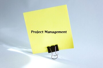 Business concept - Top view notebook writing Project Management